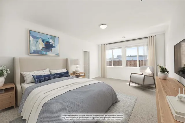 a bedroom with a bed and large windows