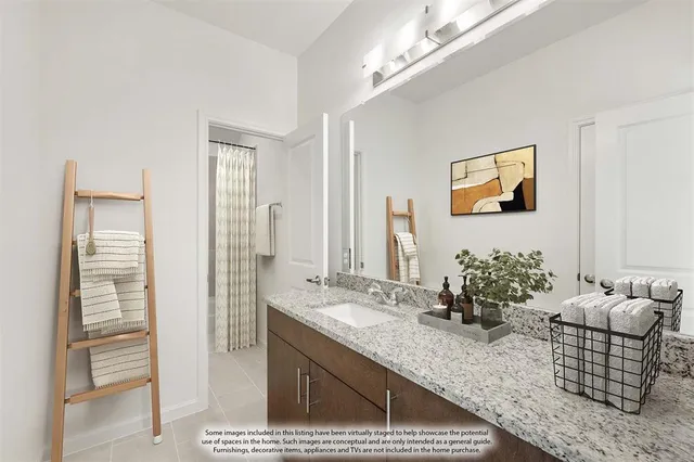 a bathroom with a granite countertop sink a large mirror and shower