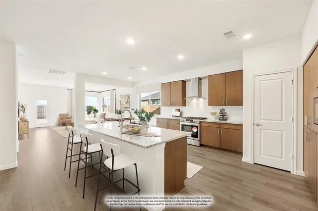 a kitchen with kitchen island granite countertop lots of counter top space and stainless steel appliances