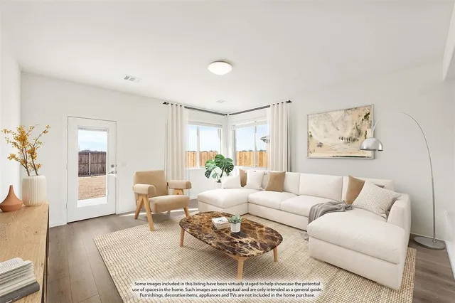 a living room with furniture a rug and a table