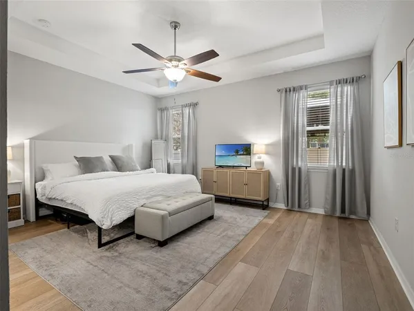 a bathroom with a toilet a sink and large mirror