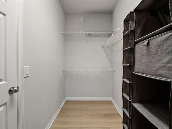 a view of a workspace with furniture and a flat screen tv