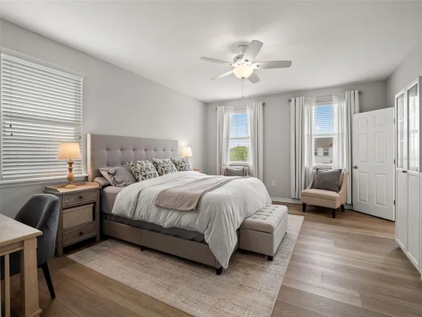 a bathroom with a sink a toilet a mirror and shower