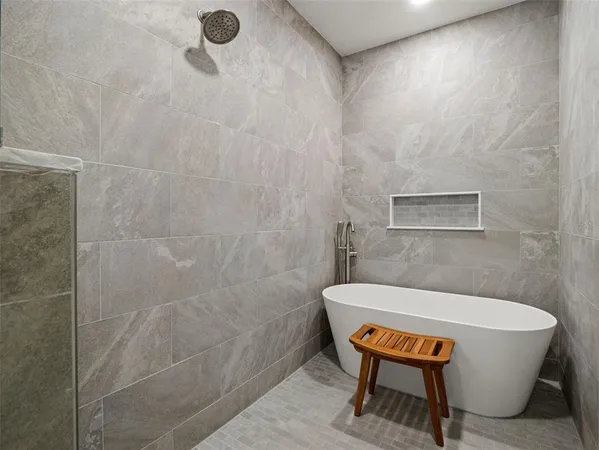 a view of swimming pool with seating area and trees in the background