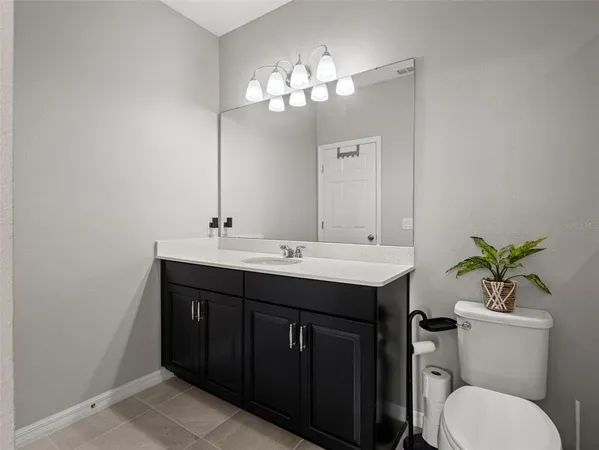 a living room with patio furniture and a potted plants