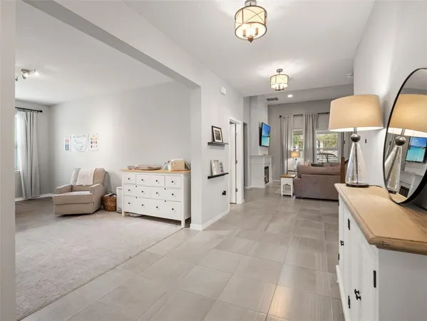 a dining room with furniture a chandelier and a rug