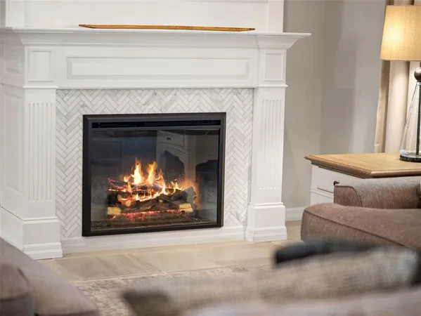 a large kitchen with a large counter top space a sink stainless steel appliances and cabinets