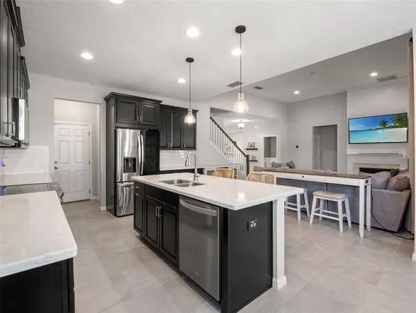 a spacious bedroom with a bed and a chandelier