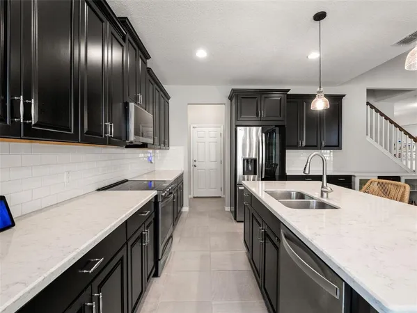 a bathroom with double vanity sink a vanity and a mirror