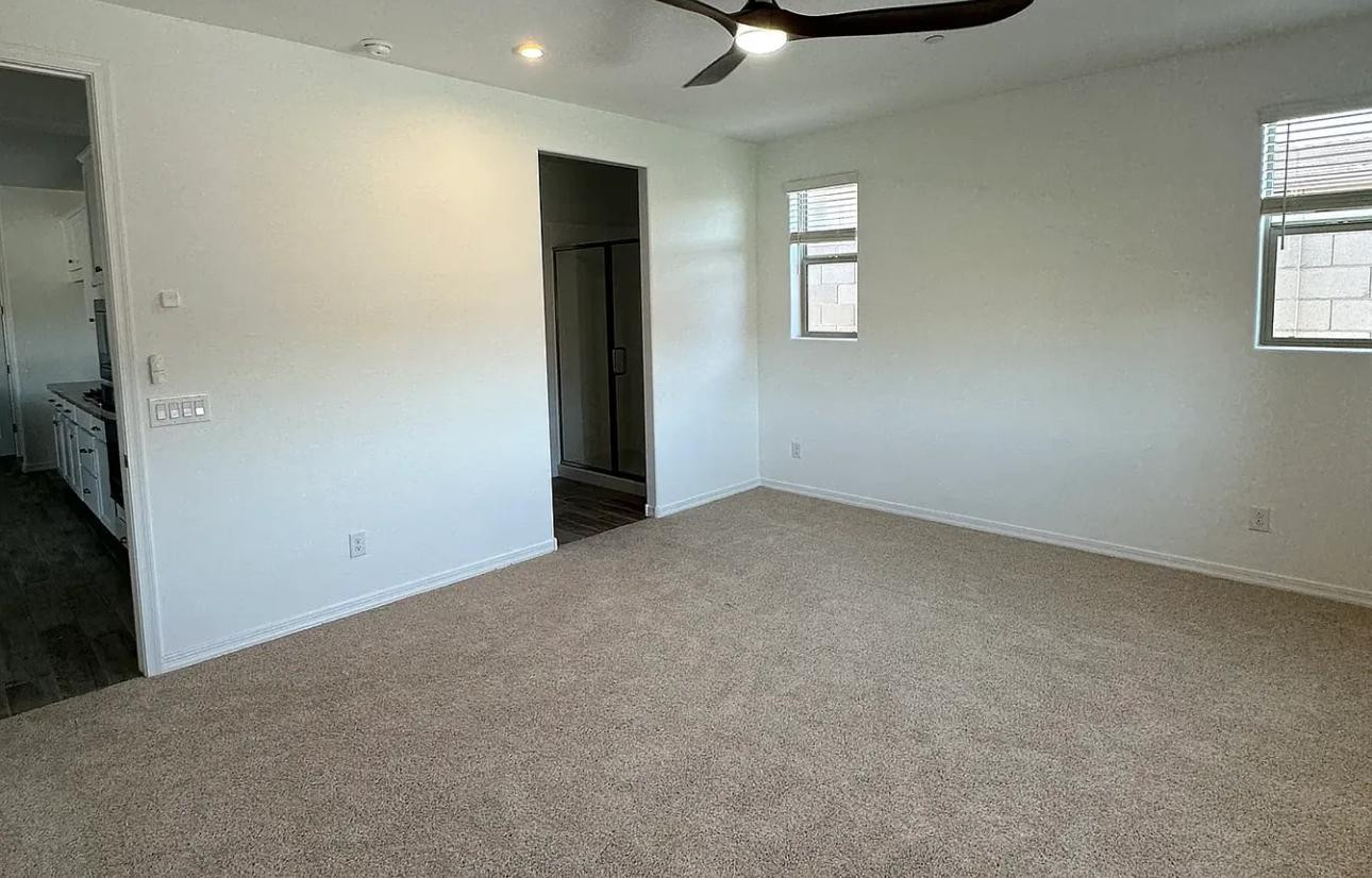 13302 West Eagle Feather Road Peoria, AZ 85383 - Photo 11 of 12 an empty room with windows and chandelier fan