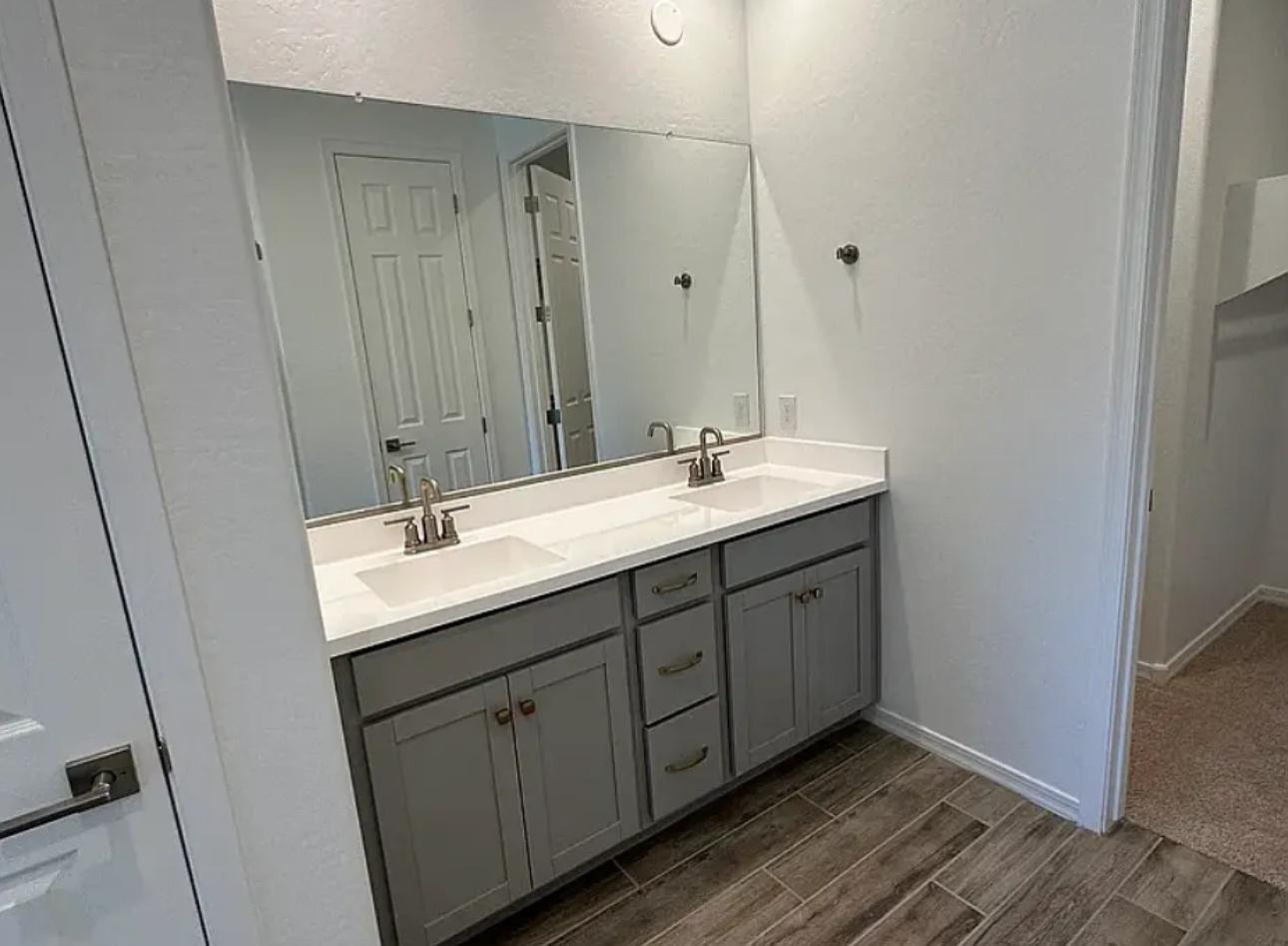 13302 West Eagle Feather Road Peoria, AZ 85383 - Photo 9 of 12 a en suite bathroom with double sink and mirror