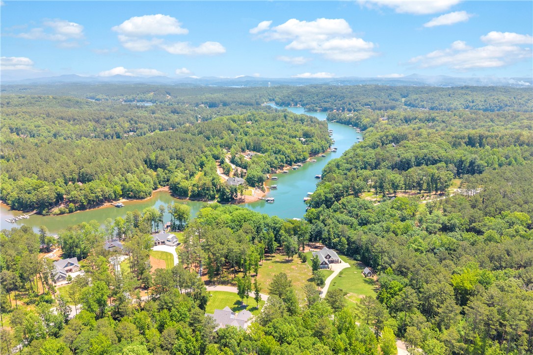 Lot 60 Harbor Point Seneca, SC 29672 - Photo 8 of 30 An aerial panorama reveals verdant forests bordering a winding lake with numerous docks and distant mountains.