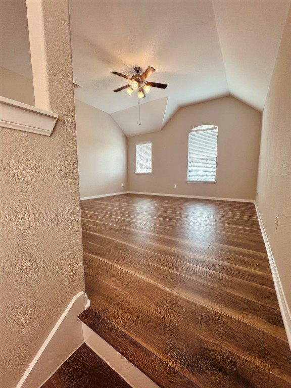 2023 Pine Ledge Road Pearland, TX 77089 - Photo 14 of 29 This room features vaulted ceilings, elegant wood flooring, and ample natural light from two windows, complete with a ceiling fan for added comfort.
