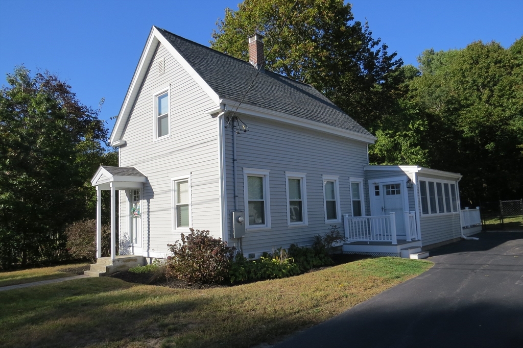 a view of a small house with garden