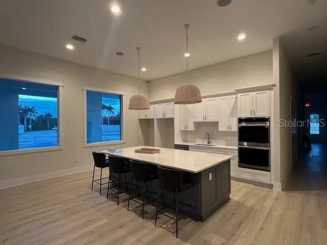 a large kitchen with a table and chairs in it