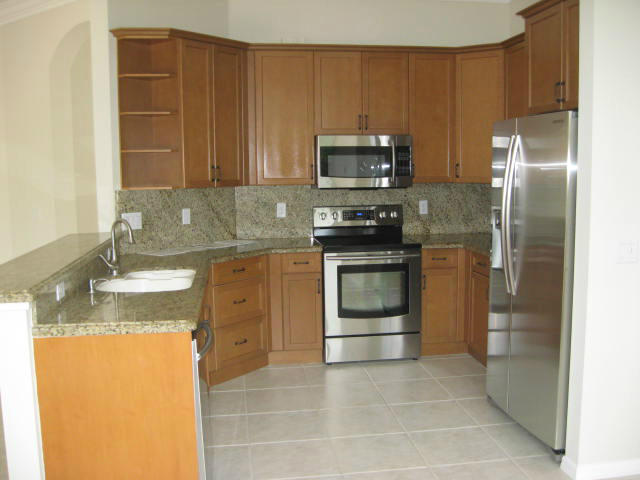 22194 Braddock Place Boca Raton, FL 33428 - Photo 3 of 20 a kitchen with stainless steel appliances granite countertop a stove a refrigerator and a sink