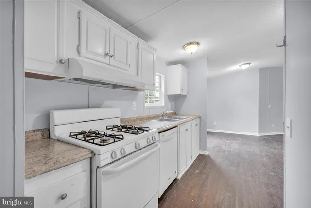 a kitchen with granite countertop cabinets and stove