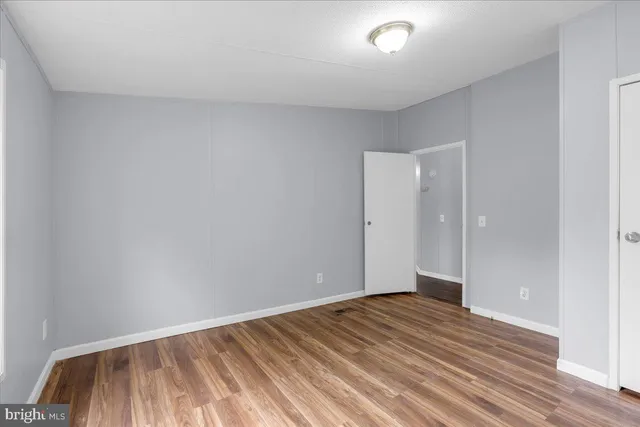 a view of an empty room and wooden floor
