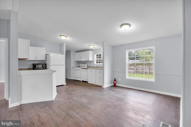 a view of kitchen with refrigerator and window