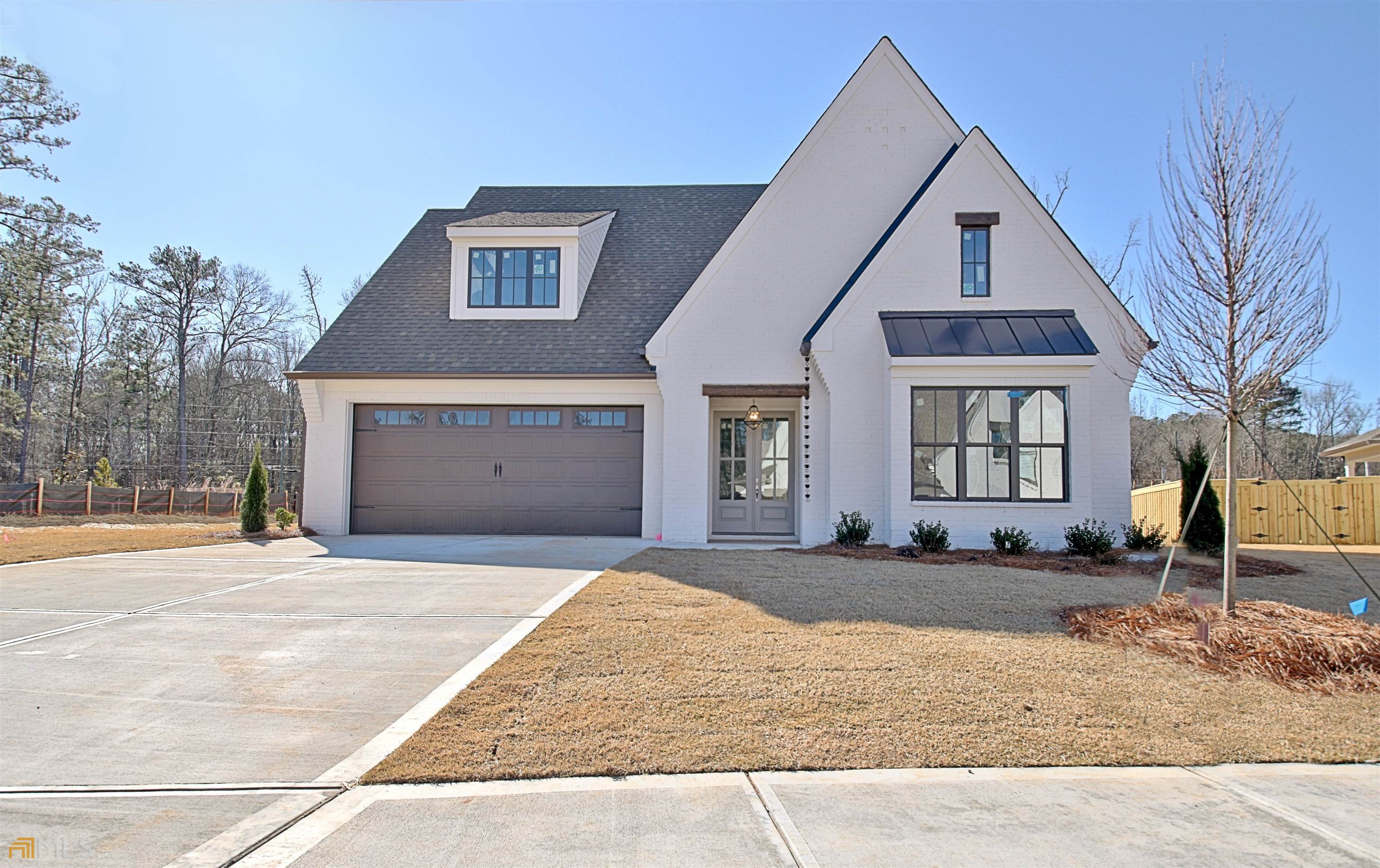 47 Dappers Landing, Unit LT12 Newnan, GA 30265 - Photo 1 of 1 a front view of a house with a yard and garage