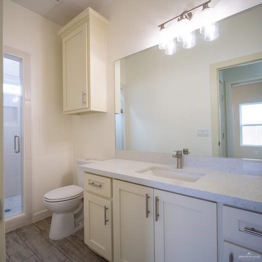 3052 Briggs Road, Unit C Weslaco, TX 78596 - Photo 13 of 16 White vanity with a light countertop, undersink storage, and a single basin