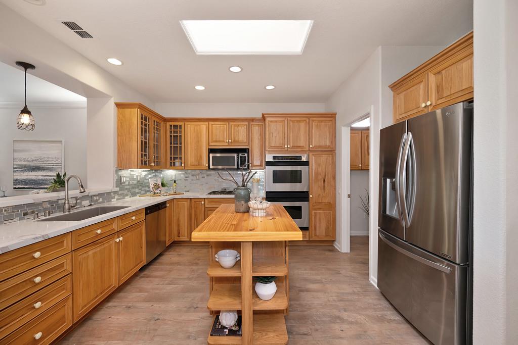6014 Timberlodge Lane Roseville, CA 95747 - Photo 13 of 63 a kitchen with stainless steel appliances a refrigerator sink and microwave