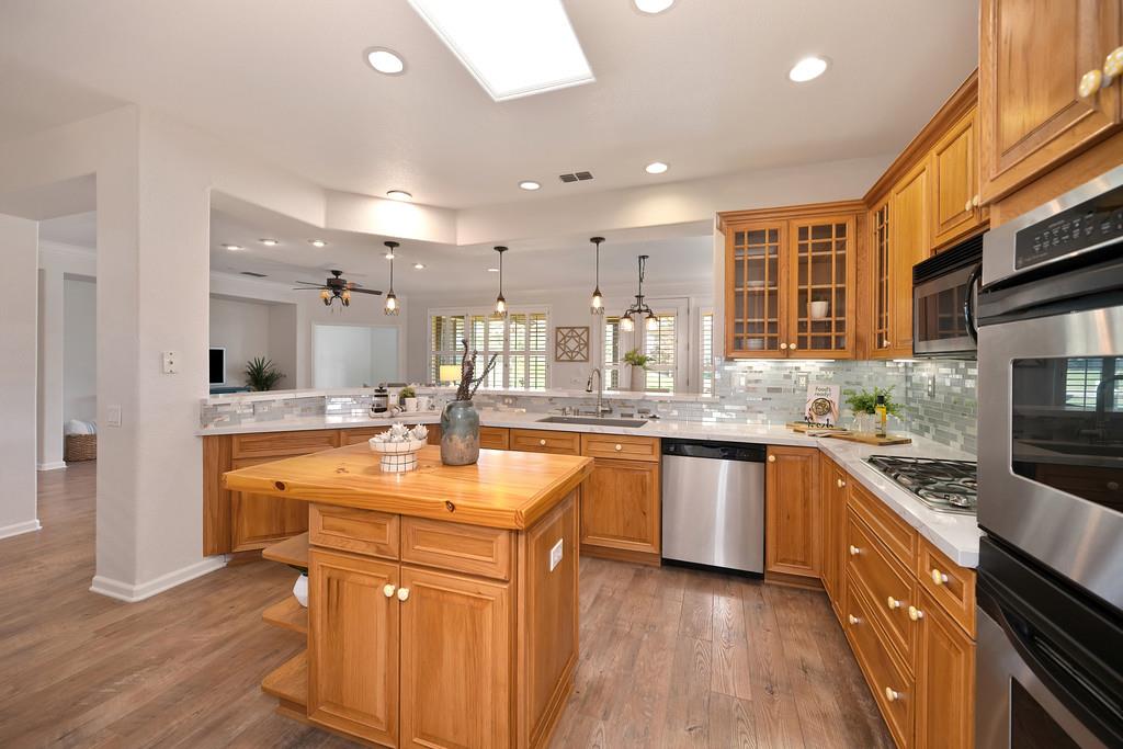 6014 Timberlodge Lane Roseville, CA 95747 - Photo 16 of 63 a kitchen with stainless steel appliances granite countertop a sink stove and refrigerator
