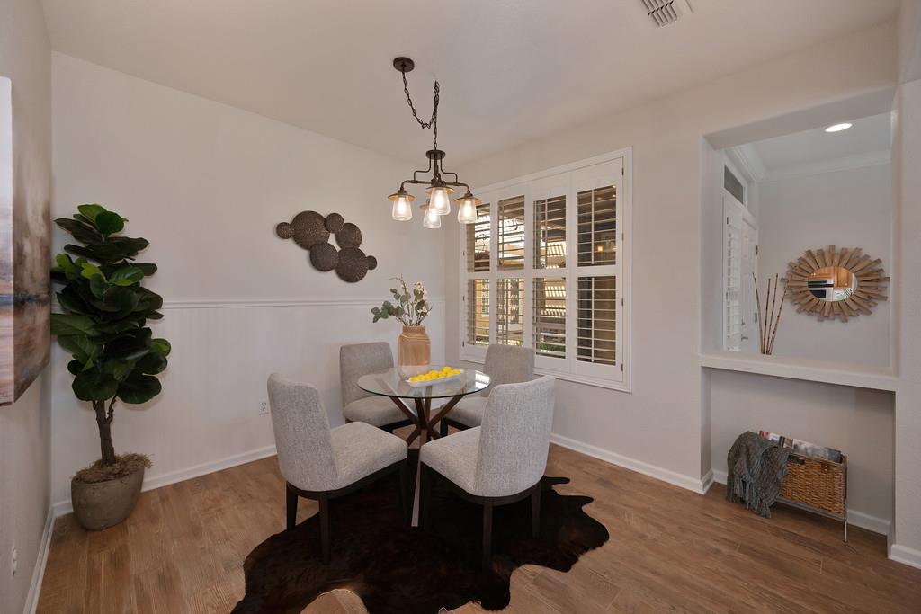6014 Timberlodge Lane Roseville, CA 95747 - Photo 20 of 63 a dining room with furniture potted plants and wooden floor