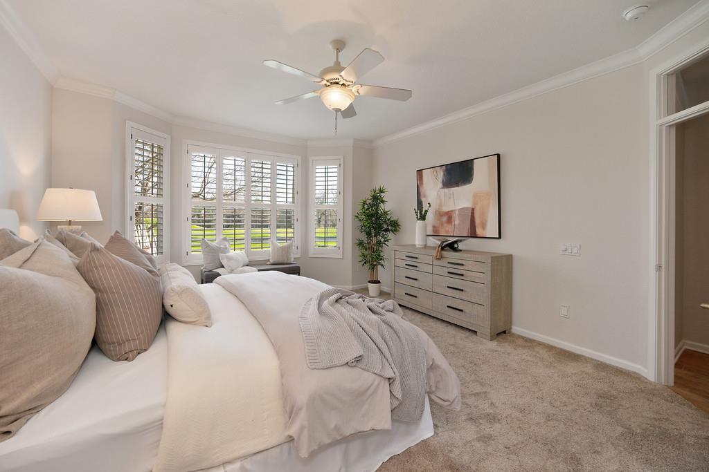 6014 Timberlodge Lane Roseville, CA 95747 - Photo 30 of 63 a bedroom with a large bed and a chandelier