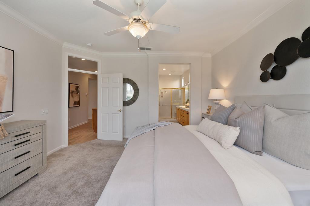 6014 Timberlodge Lane Roseville, CA 95747 - Photo 31 of 63 a bedroom with a large bed and chandelier