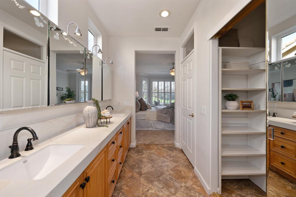 6014 Timberlodge Lane Roseville, CA 95747 - Photo 33 of 63 a bathroom with a double vanity sink a mirror and a shower
