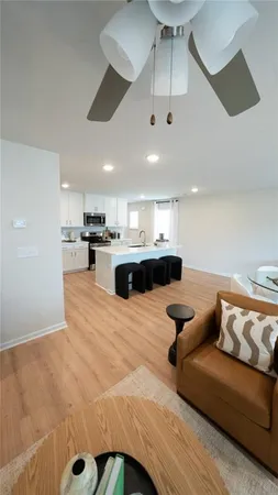 a living room with furniture and kitchen view
