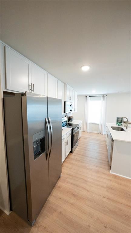 200 Harrell Way Fayetteville, GA 30215 - Photo 5 of 14 a kitchen with stainless steel appliances kitchen island granite countertop a refrigerator a sink a stove and white cabinets