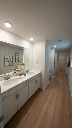 a large bathroom with a sink mirror and a toilet