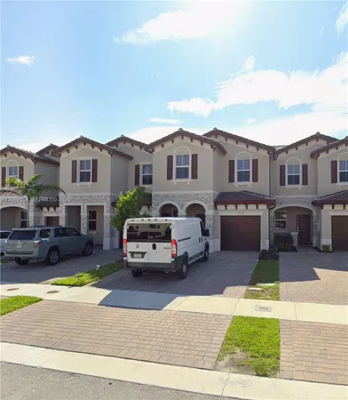 a car parked in front of a brick house