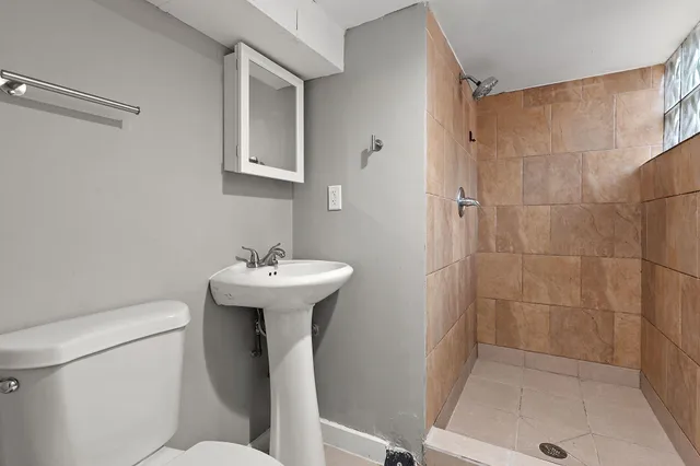 a bathroom with a sink toilet and shower