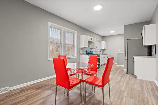 a view of a dining room with furniture and wooden floor