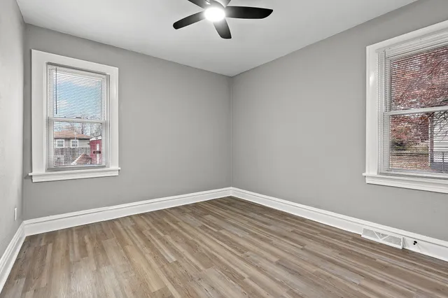a view of room with window and wooden floor