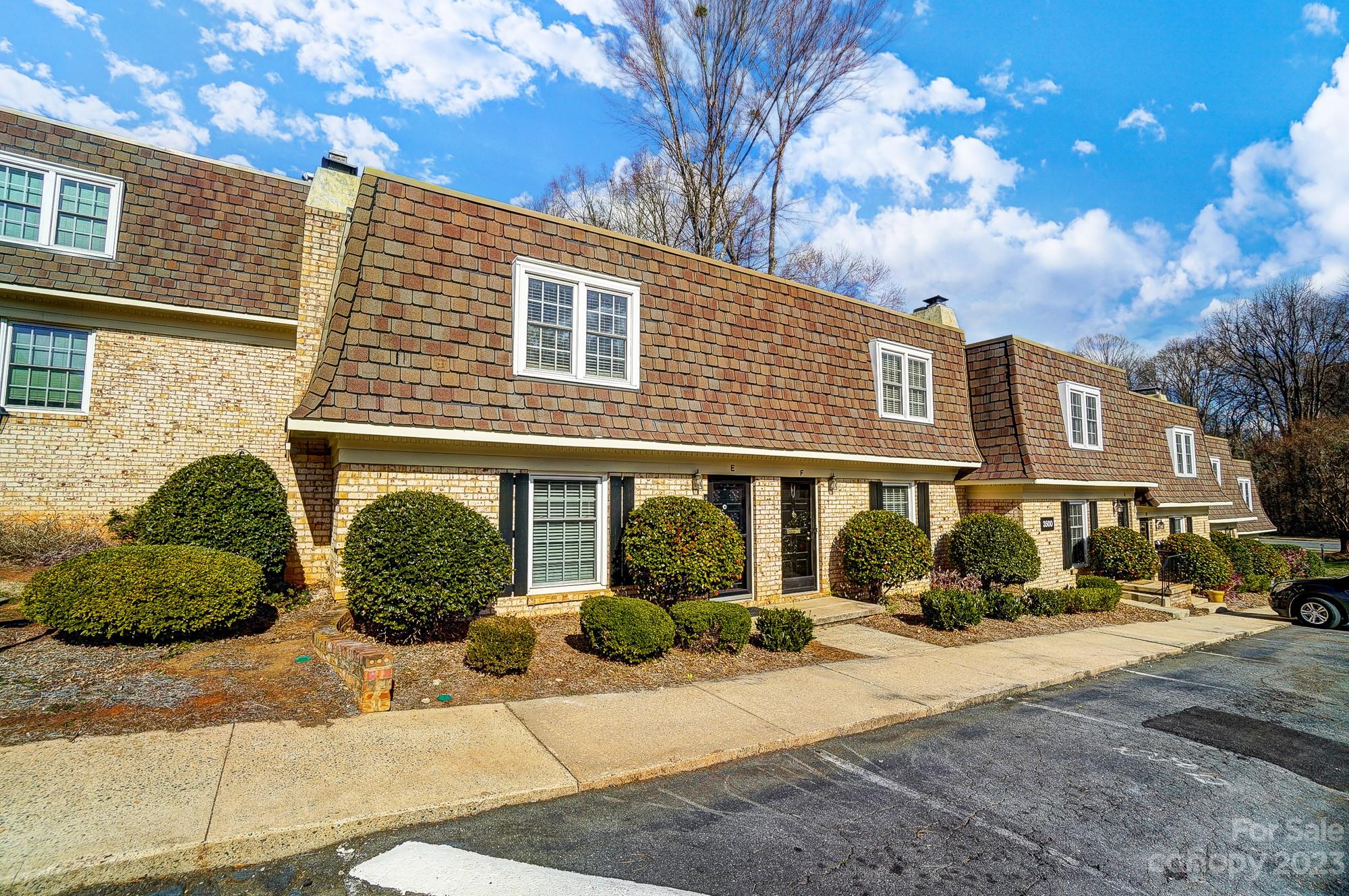 a front view of a house with a yard and outdoor seating