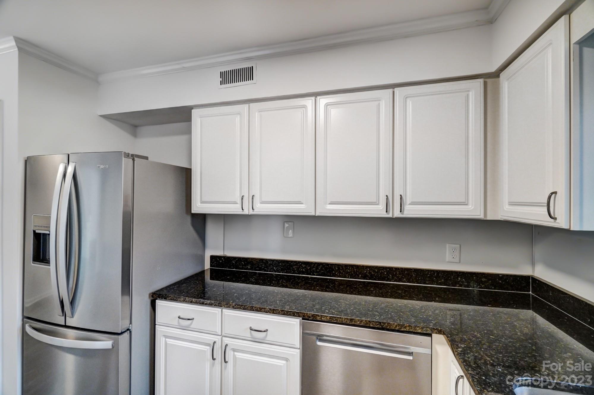 3500 Colony Road, Unit E Charlotte, NC 28211 - Photo 11 of 37 a kitchen with refrigerator a stove and cabinets