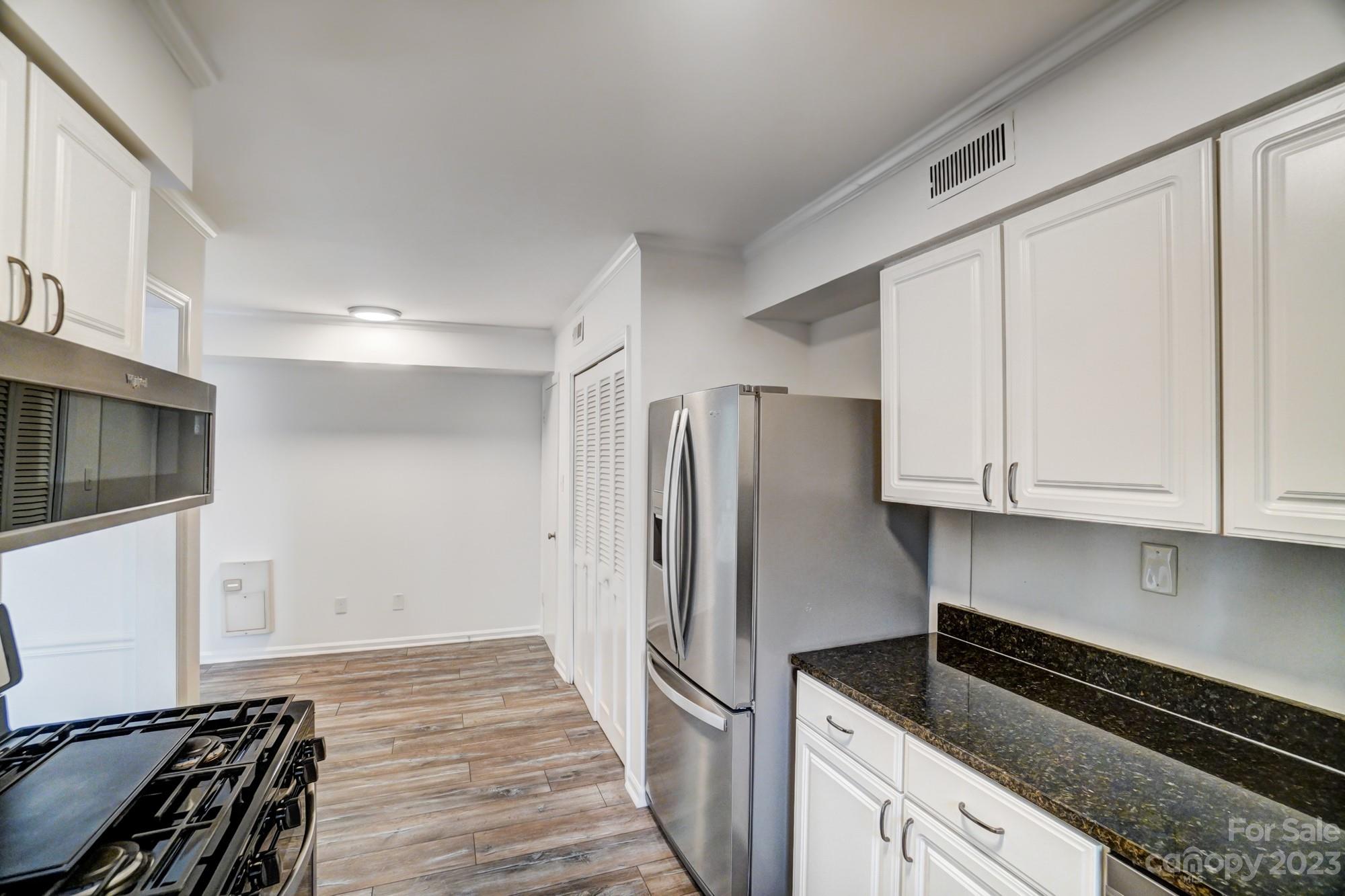 3500 Colony Road, Unit E Charlotte, NC 28211 - Photo 13 of 37 a kitchen with stainless steel appliances a refrigerator and a stove top oven