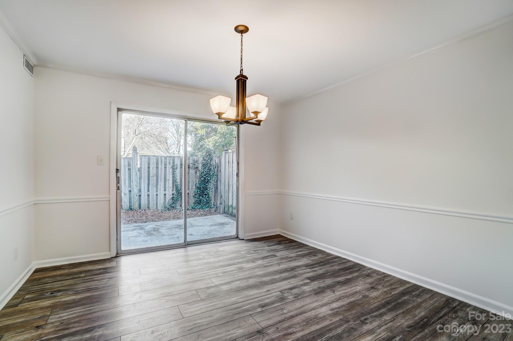 3500 Colony Road, Unit E Charlotte, NC 28211 - Photo 17 of 37 wooden floor in an empty room with a window