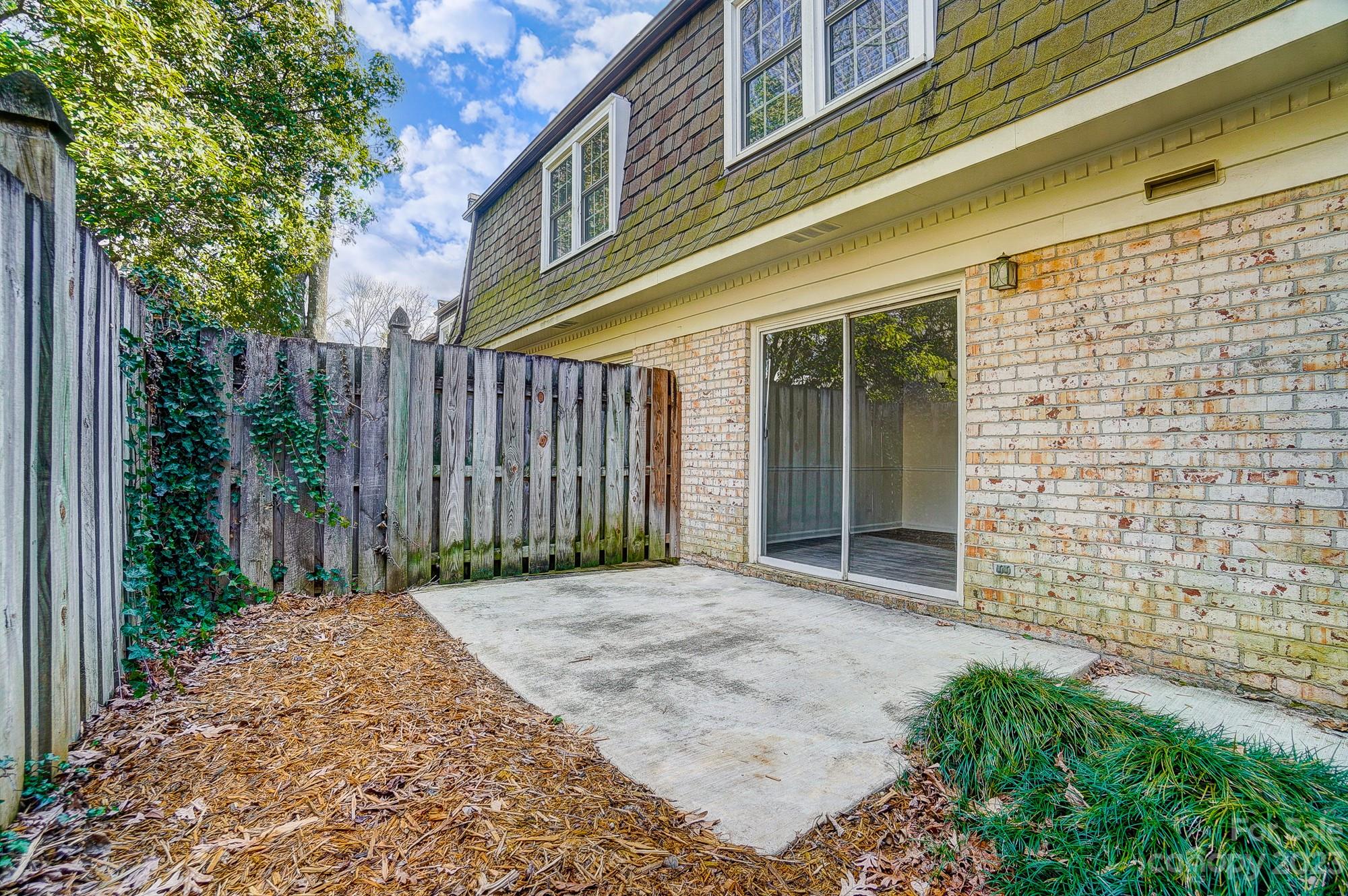 3500 Colony Road, Unit E Charlotte, NC 28211 - Photo 20 of 37 a view of backyard with large trees and wooden fence