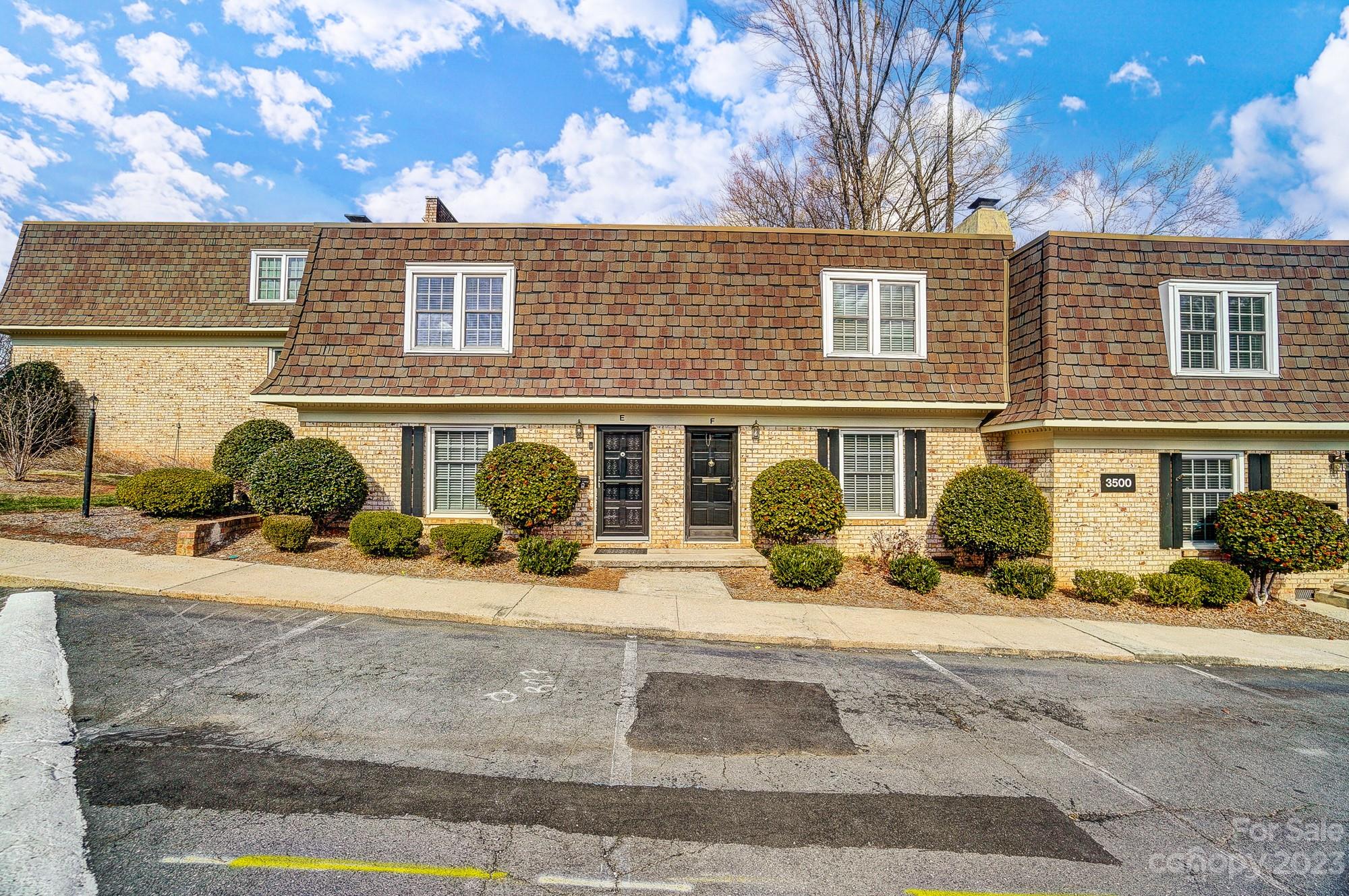 3500 Colony Road, Unit E Charlotte, NC 28211 - Photo 2 of 37 a front view of a house with a yard and a garage