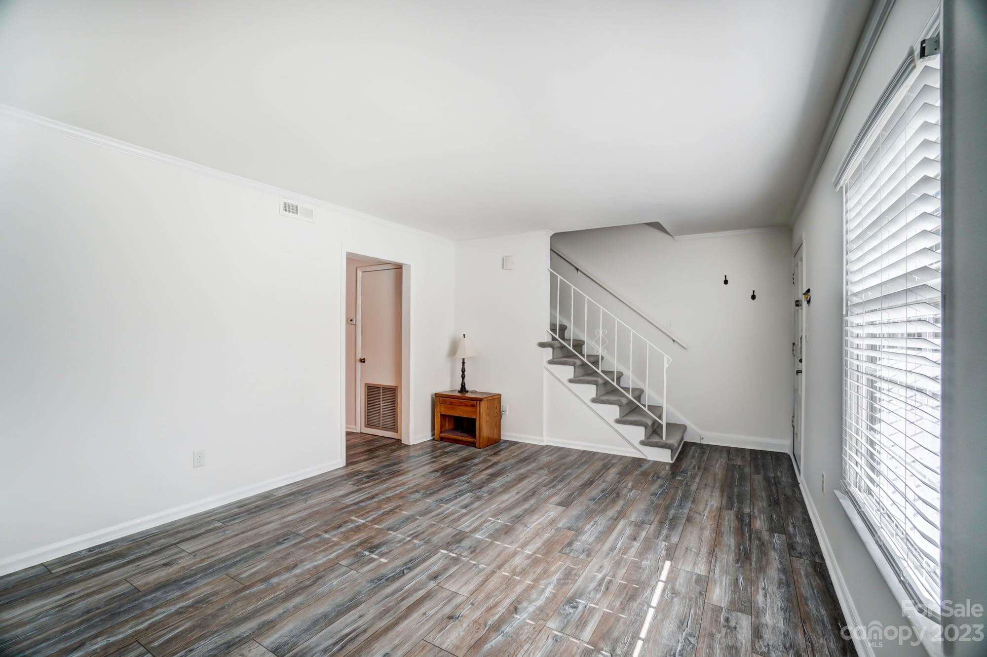 3500 Colony Road, Unit E Charlotte, NC 28211 - Photo 22 of 37 a view of empty room with wooden floor and fan