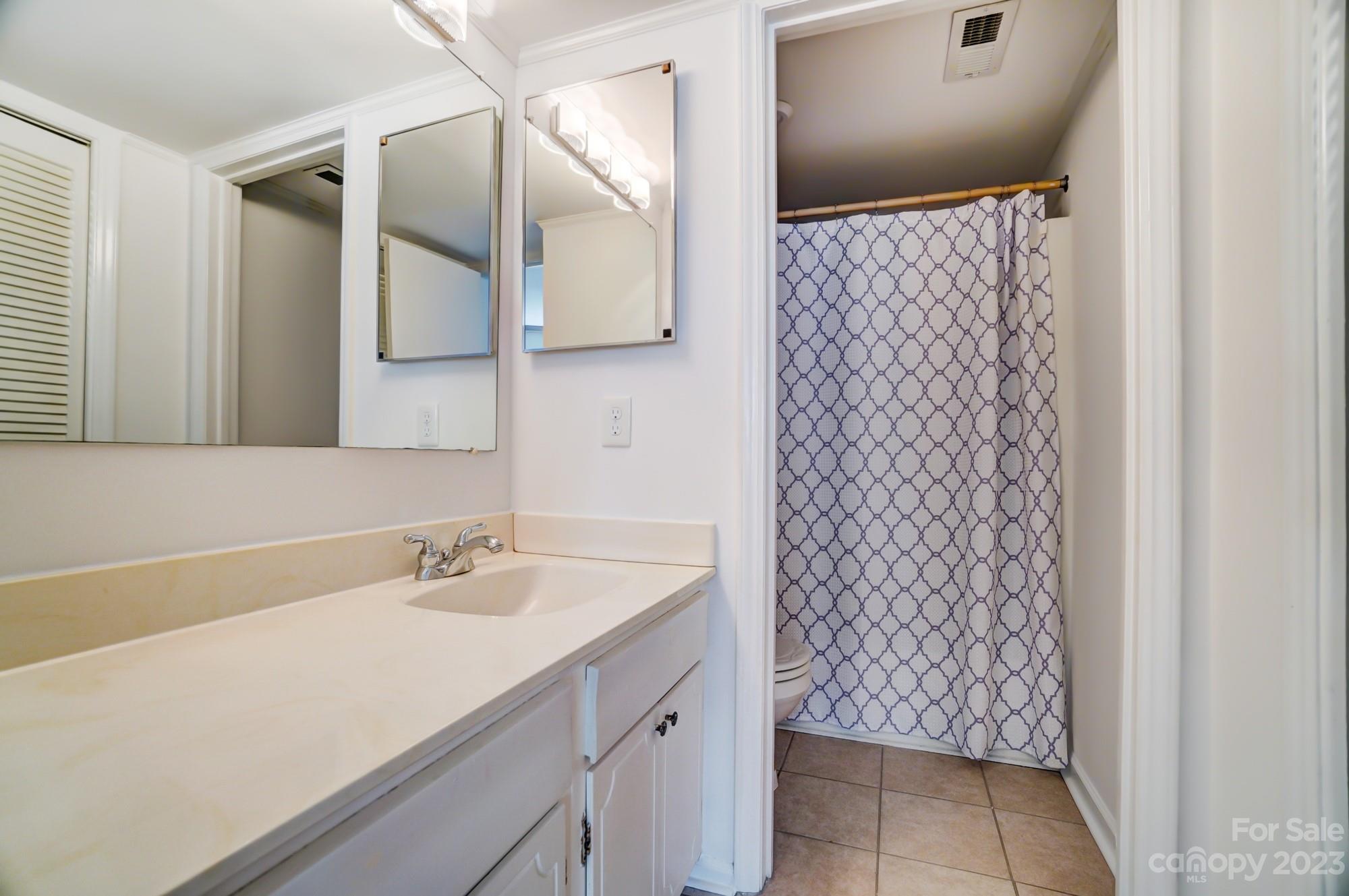 3500 Colony Road, Unit E Charlotte, NC 28211 - Photo 27 of 37 a bathroom with a sink a vanity and a mirror