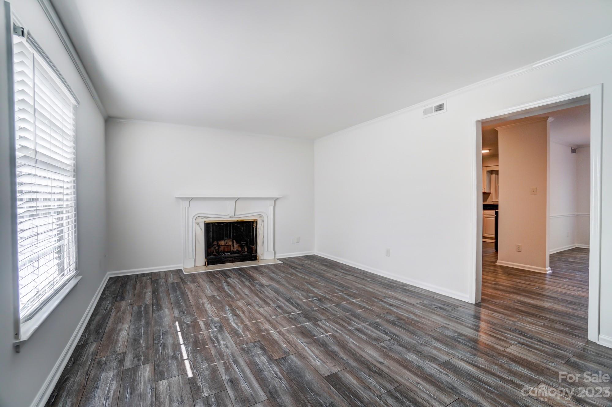 3500 Colony Road, Unit E Charlotte, NC 28211 - Photo 3 of 37 wooden floor fireplace and windows in an empty room