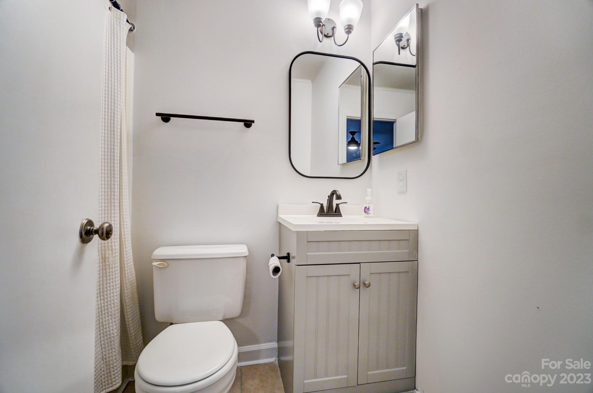 3500 Colony Road, Unit E Charlotte, NC 28211 - Photo 32 of 37 a bathroom with a toilet sink and mirror