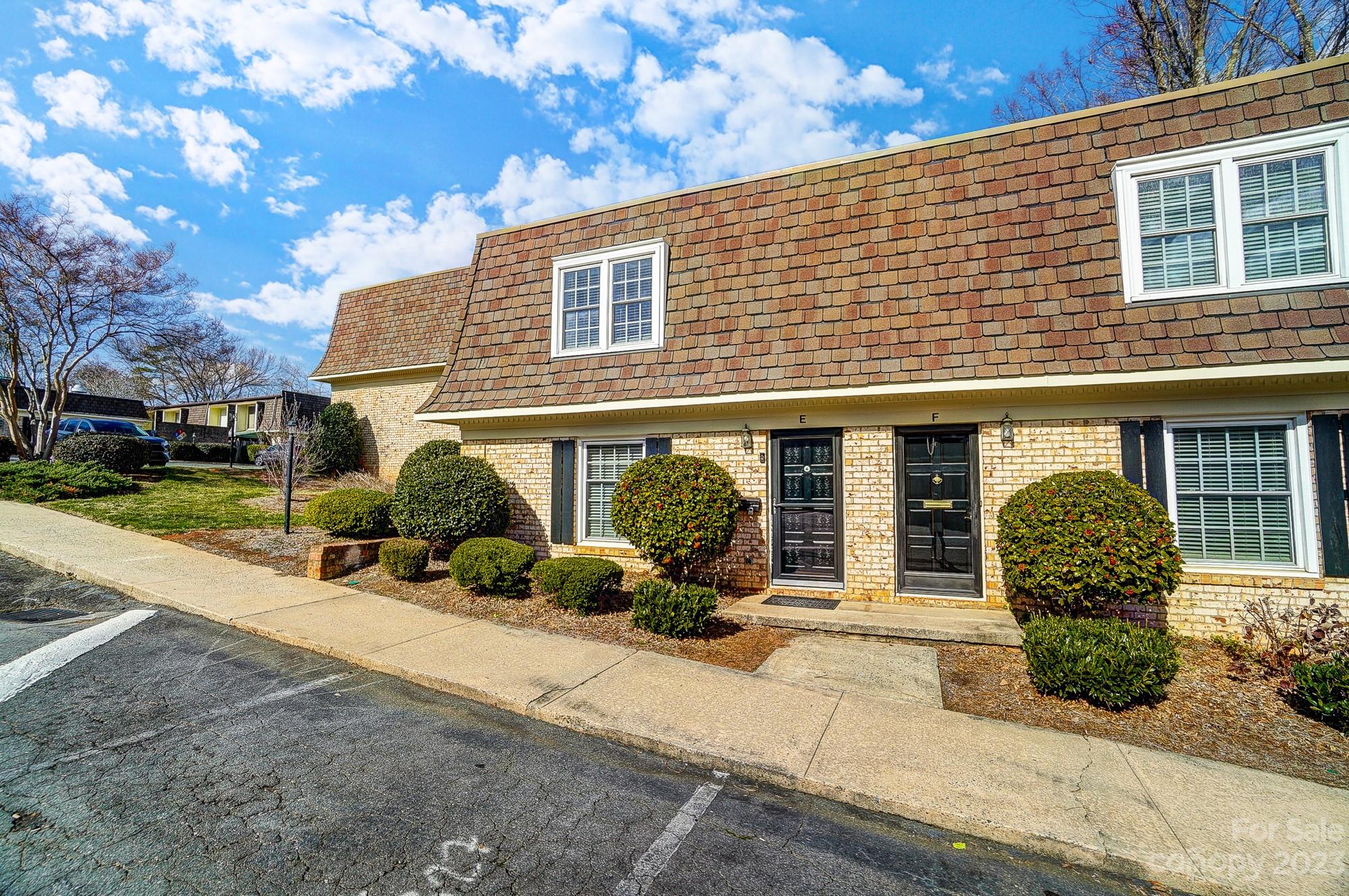 3500 Colony Road, Unit E Charlotte, NC 28211 - Photo 34 of 37 a front view of a house with a yard and potted plants