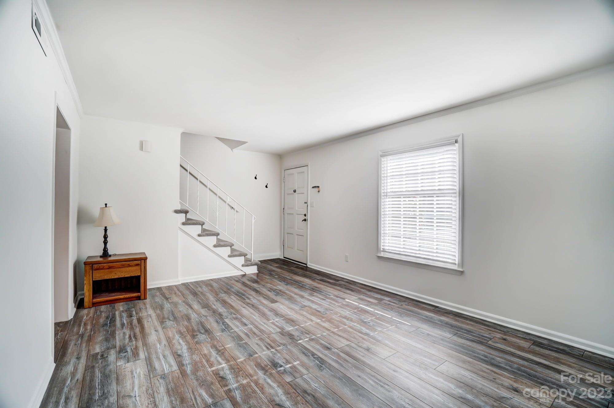 3500 Colony Road, Unit E Charlotte, NC 28211 - Photo 5 of 37 wooden floor in an empty room with a window